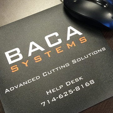 BACA Systems help desk phone number printed on a black mouse pad